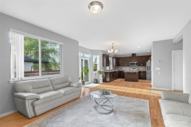 11511 SE 244th, Kent, WA 98030 - living area featuring a chandelier, light wood-type flooring, recessed lighting, and baseboards