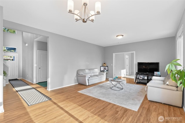 11511 SE 244th, Kent, WA 98030 - living room with wood finished floors, a chandelier, and baseboards