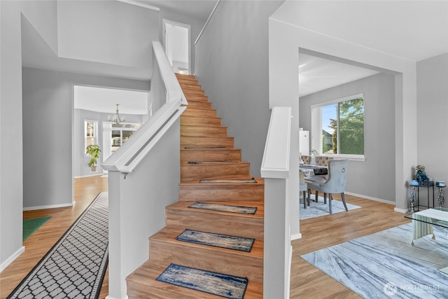 11511 SE 244th, Kent, WA 98030 - stairway with wood finished floors, baseboards, and a chandelier