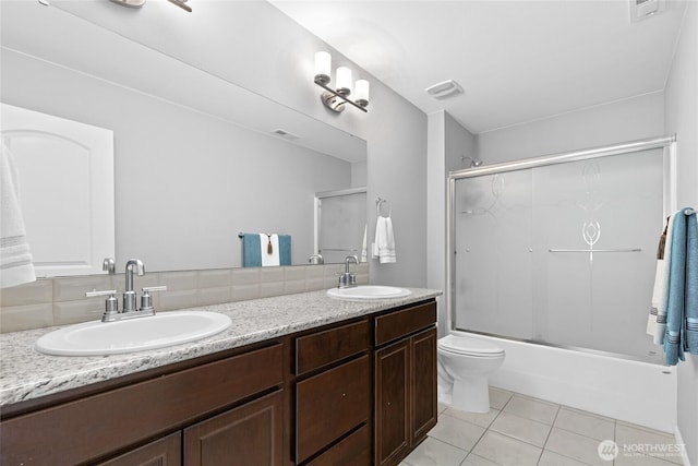 11511 SE 244th, Kent, WA 98030 - full bathroom featuring tile patterned flooring, double vanity, backsplash, toilet, and combined bath / shower with glass door