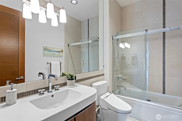 8631 NE 19th Pl, Clyde Hill, WA 98004 - bathroom with tile walls, shower / bath combination with glass door, toilet, and vanity