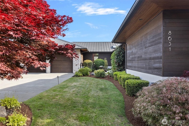 8631 NE 19th Pl, Clyde Hill, WA 98004 - view of home's exterior featuring a standing seam roof, metal roof, a yard, a garage, and driveway