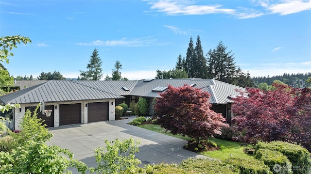 8631 NE 19th Pl, Clyde Hill, WA 98004 - view of front of house featuring a standing seam roof, metal roof, an attached garage, and driveway