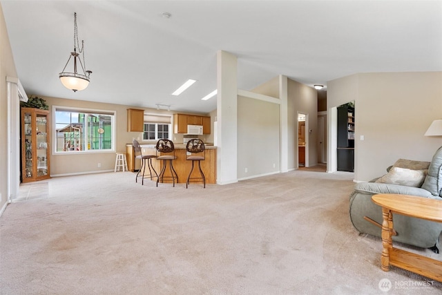 154 Mossyrock Rd W Unit 5, Mossyrock, WA 98564 - living area featuring lofted ceiling, baseboards, light colored carpet, and bar area