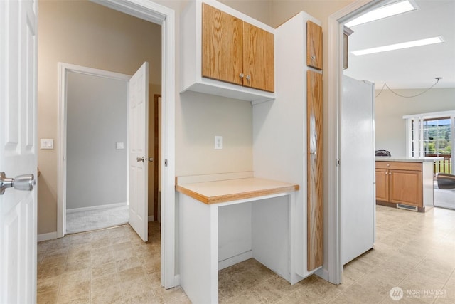 154 Mossyrock Rd W Unit 5, Mossyrock, WA 98564 - kitchen with light countertops, freestanding refrigerator, brown cabinets, and light floors