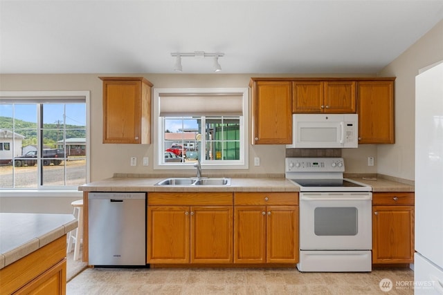154 Mossyrock Rd W Unit 5, Mossyrock, WA 98564 - kitchen featuring white appliances, a sink, and brown cabinetry