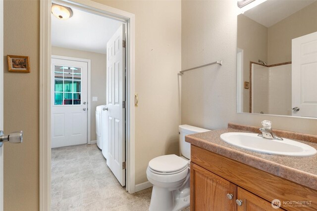 154 Mossyrock Rd W Unit 5, Mossyrock, WA 98564 - bathroom with toilet, vanity, a shower, and washer / clothes dryer