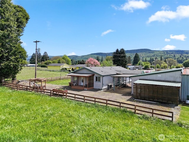 154 Mossyrock Rd W Unit 5, Mossyrock, WA 98564 - back of house featuring a mountain view and fence