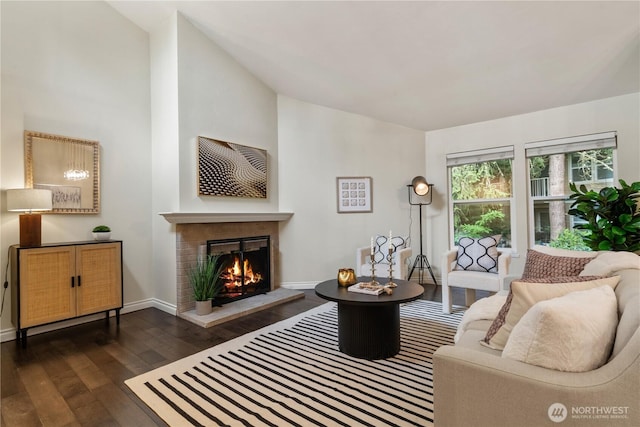 14651 NE 40th St Unit C4, Bellevue, WA 98007 - living area featuring dark wood finished floors, a warm lit fireplace, baseboards, and lofted ceiling