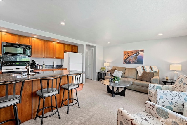 living room with light colored carpet and recessed lighting