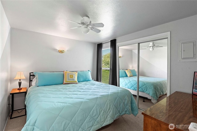 carpeted bedroom featuring a closet and ceiling fan