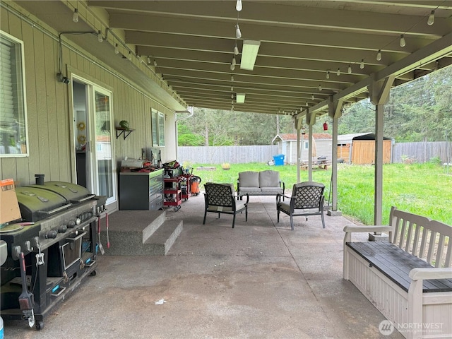 21614 82nd Avenue Ct E, Spanaway, WA 68718 - view of patio featuring a shed, an outdoor hangout area, grilling area, and an outdoor structure