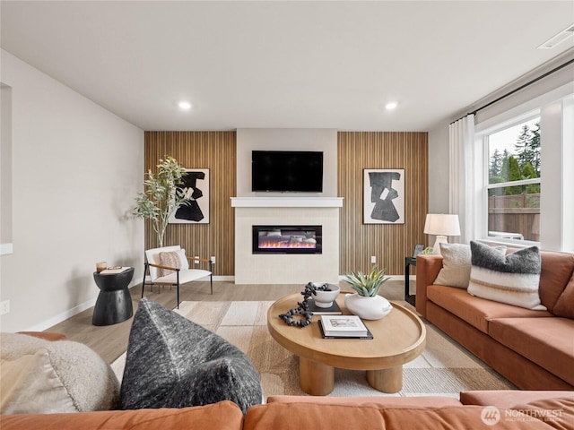 8302 114th Ave SE Unit 29, Newcastle, WA 98056 - living area featuring wood finished floors, recessed lighting, and a glass covered fireplace