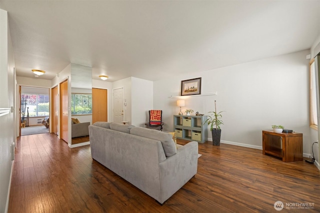 living room featuring dark wood finished floors and baseboards