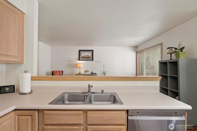 kitchen featuring dishwasher, a sink, light brown cabinetry, and light countertops