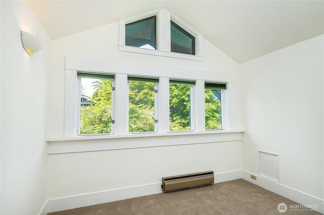 unfurnished room with baseboard heating, lofted ceiling, carpet, healthy amount of natural light, and baseboards