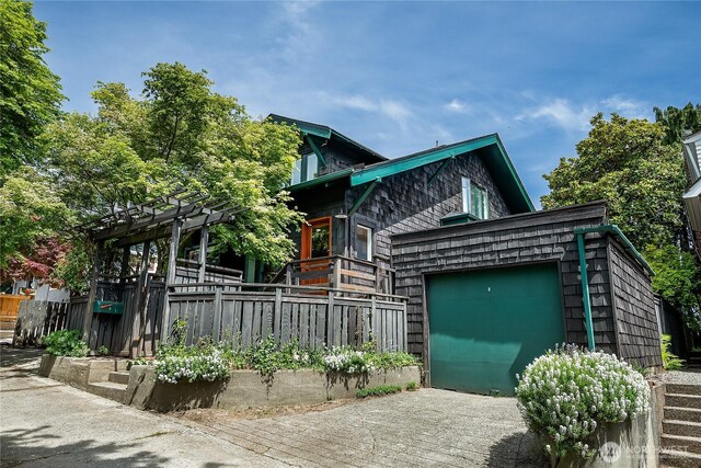 view of front of property with fence and an attached garage