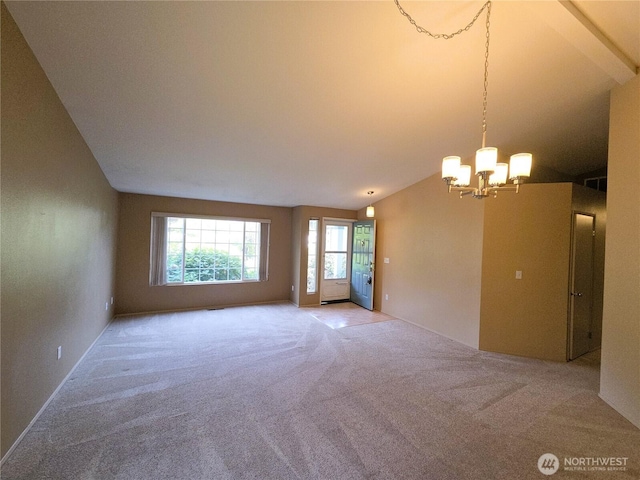 7509 43rd Ave SE, Lacey, WA 98503 - empty room featuring a chandelier, vaulted ceiling, and carpet flooring