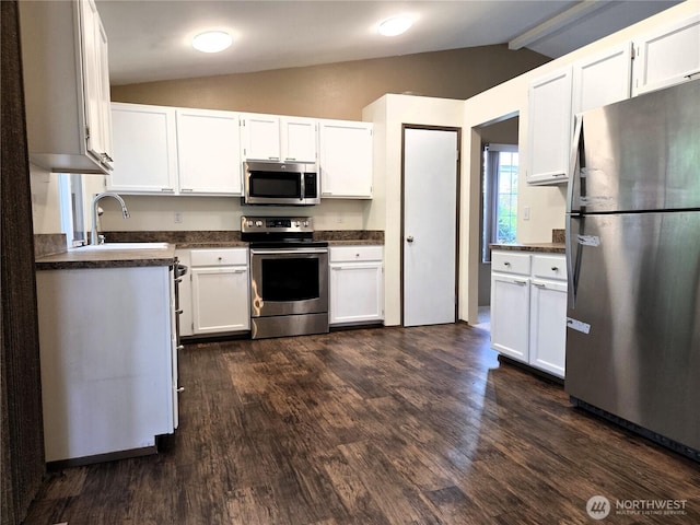 7509 43rd Ave SE, Lacey, WA 98503 - kitchen featuring appliances with stainless steel finishes, a sink, dark countertops, dark wood-type flooring, and white cabinets