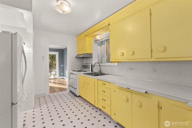 1250 N Broadway St, Aberdeen, WA 98520 - kitchen featuring white appliances, extractor fan, light countertops, light flooring, and yellow cabinetry