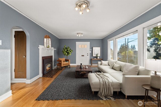 1250 N Broadway St, Aberdeen, WA 98520 - living area with ornamental molding, arched walkways, light wood-style floors, and a fireplace