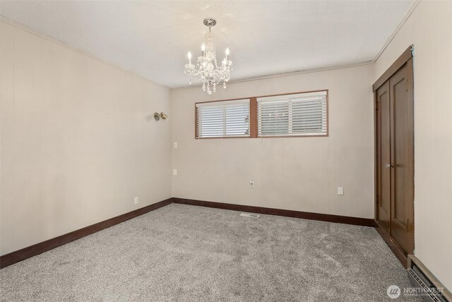 1250 N Broadway St, Aberdeen, WA 98520 - carpeted spare room featuring a chandelier, a baseboard heating unit, and crown molding
