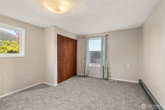 1250 N Broadway St, Aberdeen, WA 98520 - unfurnished bedroom featuring baseboard heating, carpet, and a closet