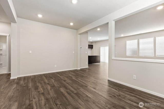 28203 74th Dr NW Unit 82, Stanwood, WA 98292 - unfurnished living room featuring dark wood-type flooring, baseboards, and recessed lighting