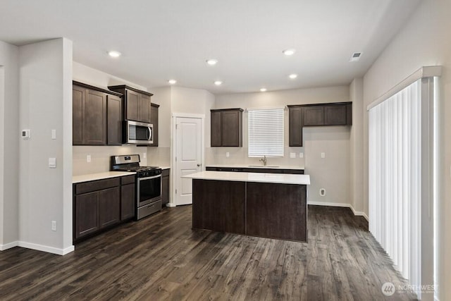 28203 74th Dr NW Unit 82, Stanwood, WA 98292 - kitchen with appliances with stainless steel finishes, a sink, dark wood-style floors, dark brown cabinets, and recessed lighting