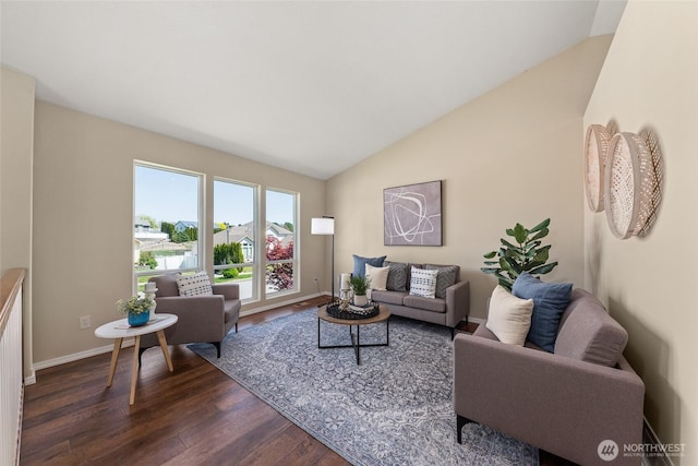 living room with lofted ceiling, dark wood finished floors, and baseboards