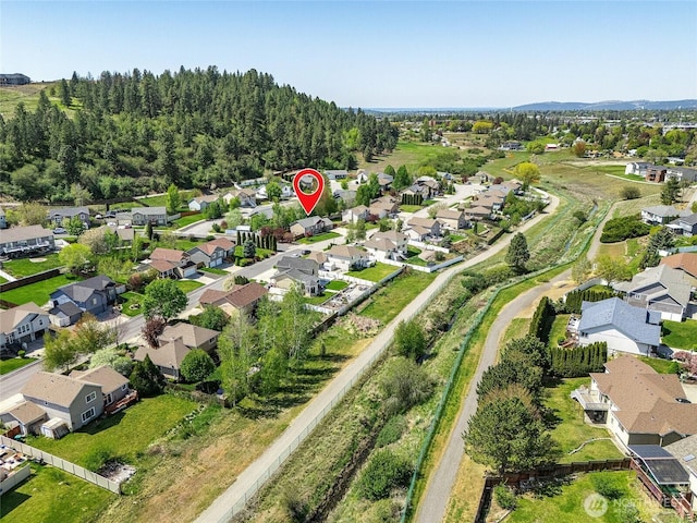 aerial view of property and surrounding area featuring nearby suburban area