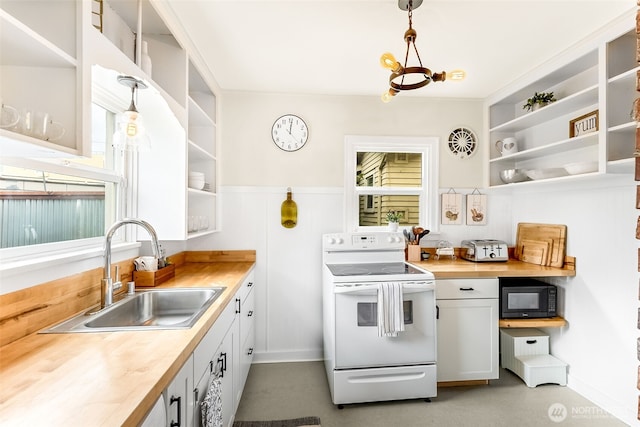 kitchen featuring electric stove, open shelves, a sink, black microwave, and decorative light fixtures