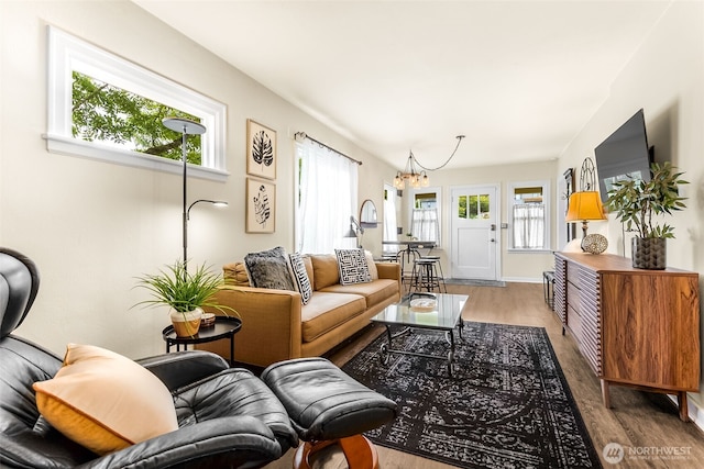 living room featuring a chandelier and wood finished floors