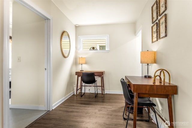 office area with dark wood-type flooring and baseboards