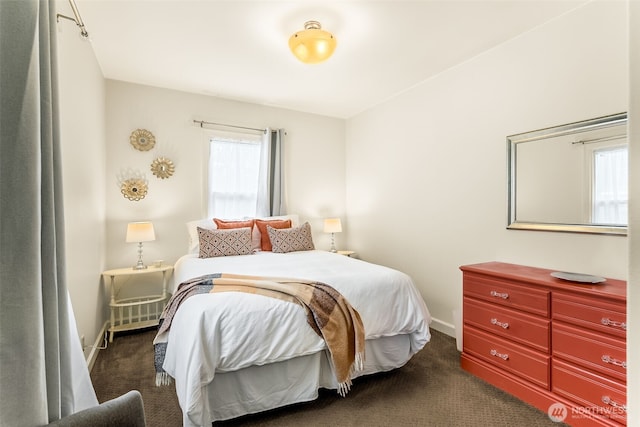 bedroom with multiple windows, carpet, and baseboards