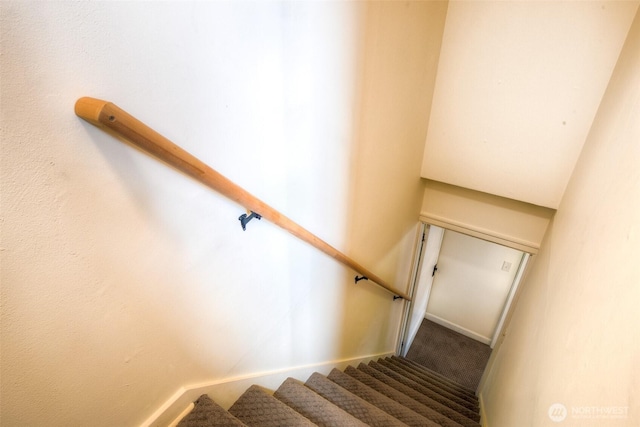 staircase with baseboards and carpet