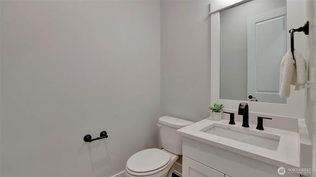 bathroom with toilet and vanity