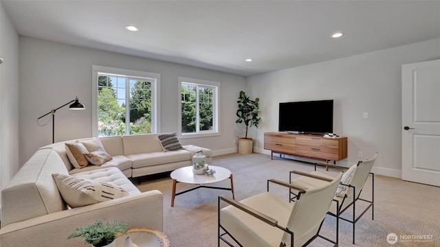 living room with light colored carpet, recessed lighting, and baseboards