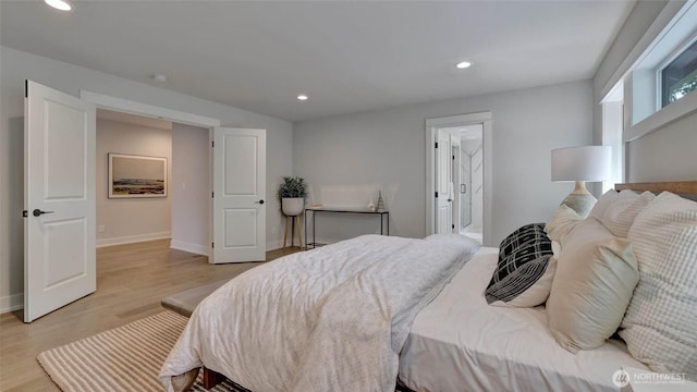 bedroom featuring light wood-type flooring, recessed lighting, and baseboards