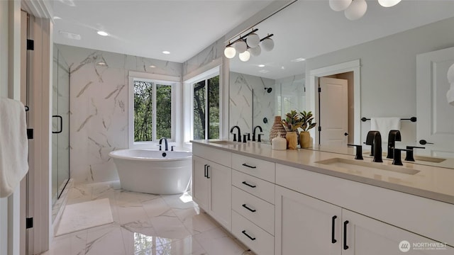bathroom with a marble finish shower, marble tiled floors, double vanity, and a freestanding bath