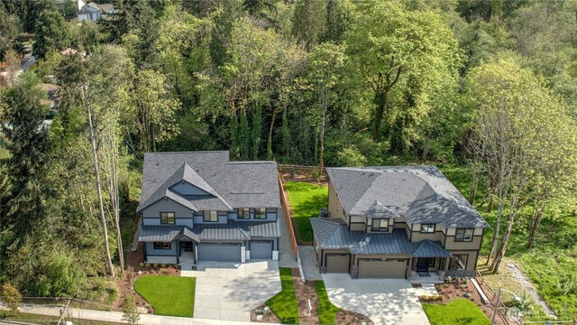 aerial view of property and surrounding area with a forest