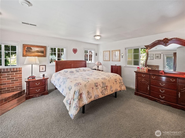 carpeted bedroom featuring multiple windows