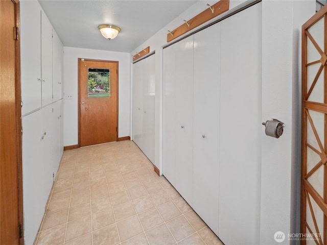 corridor featuring light tile patterned floors
