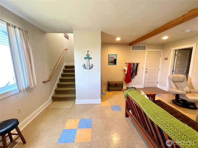 living room featuring stairs, baseboards, healthy amount of natural light, recessed lighting, and beamed ceiling