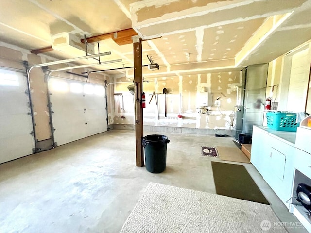garage with washing machine and clothes dryer and a garage door opener