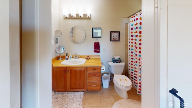 bathroom with toilet, vanity, tile patterned floors, and curtained shower