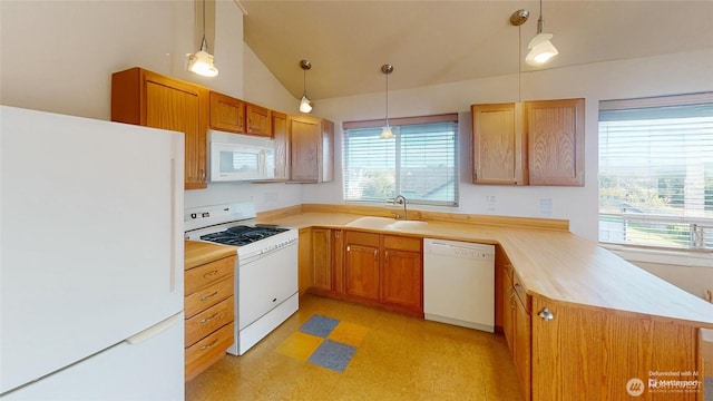 kitchen with white appliances, a sink, light countertops, a peninsula, and hanging light fixtures