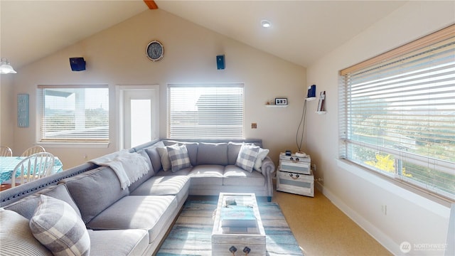 carpeted living room with lofted ceiling and baseboards