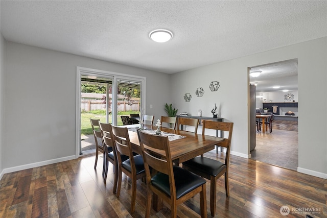 2505 Angela St SE, Lacey, WA 98503 - dining space featuring dark wood-type flooring, a textured ceiling, and baseboards
