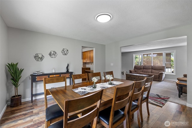 2505 Angela St SE, Lacey, WA 98503 - dining area featuring wood finished floors, baseboards, and a textured ceiling